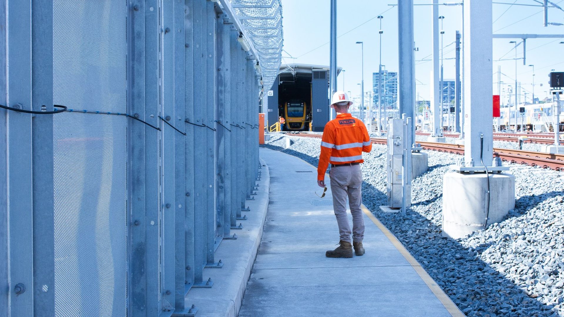 Fencepac worker installing high-security fencing at rail yard