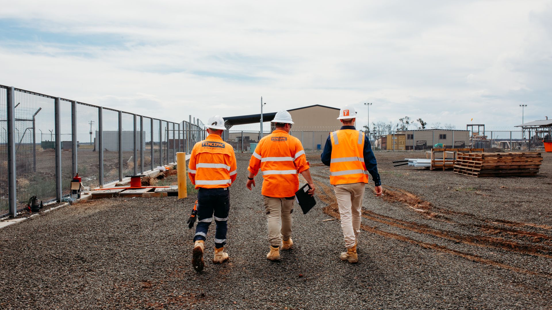 Fencepac crew walking through 358 mesh security corridor from behind