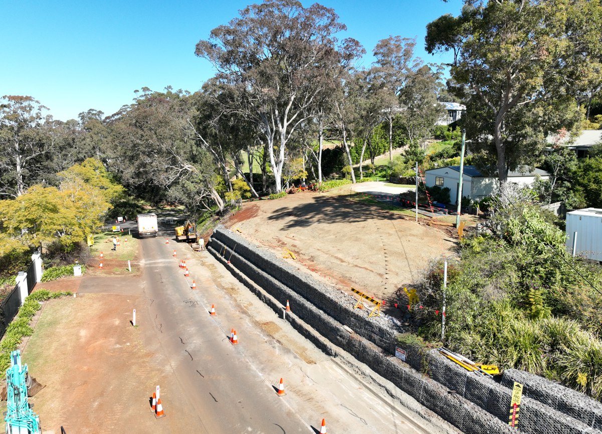 Massive gabion retaining wall aerial view with red earth and bushland